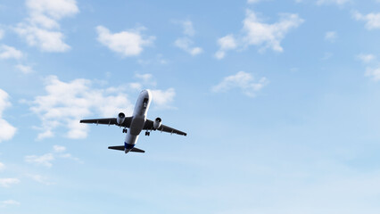 Fototapeta premium Commercial passenger airplane flying through the sky and taking off, ideal for aviation, air travel, tourism, transportation, airline, and travel content.