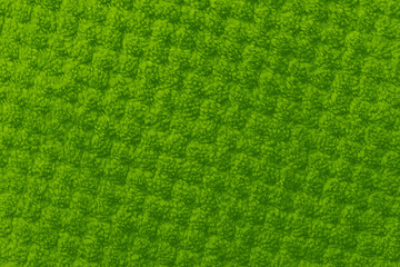 Green fuzzy fabric texture close up © reddish