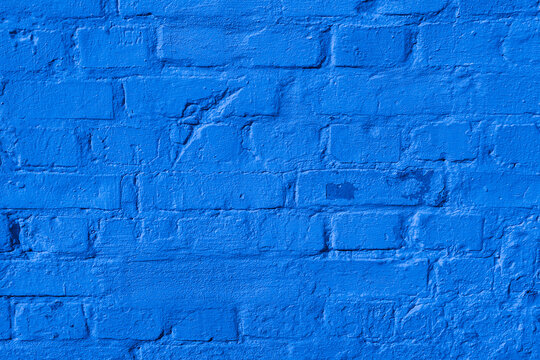 Bright blue painted brick wall texture background