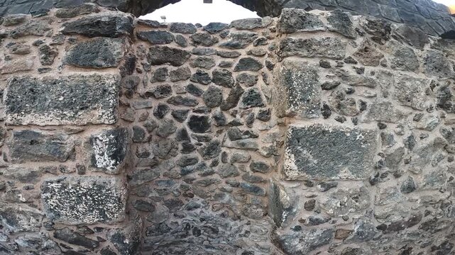Historic stone walls and prayer rugs at Masjid Bani Anif in Madinah, Saudi Arabia.