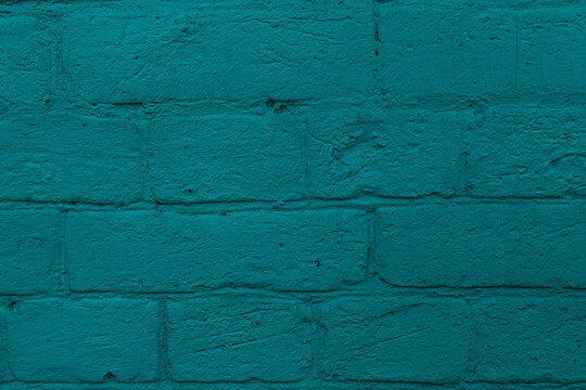 Textured teal painted brick wall surface