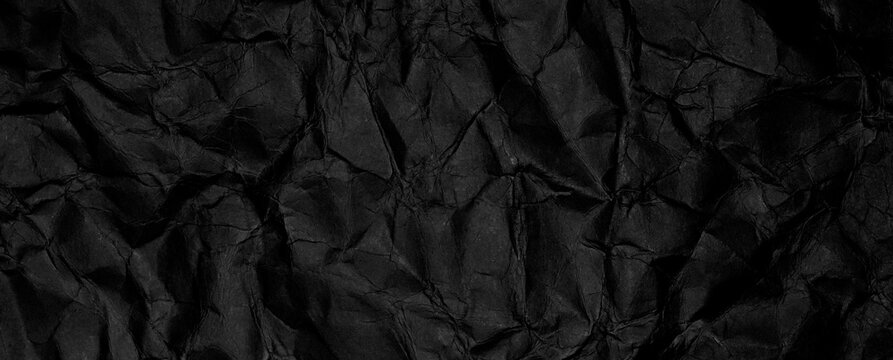 Banner con texture di carta nera stropicciata con pieghe profonde e superficie grunge