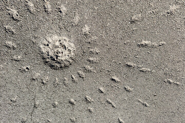 Artillery shell impact crater on a damaged rough road background © reddish
