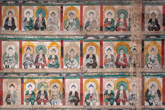 Ancient Buddhist wall mural in Zhenguo Temple, Pingyao, Shanxi, China, rows of seated Buddha figures
