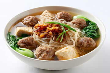 Fototapeta premium Full Bowl of Delicious Noodles with Meatballs and Vegetables on a Pure White Seamless Background