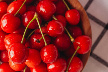 Fresh red cherries with water droplets in a bowl © reddish