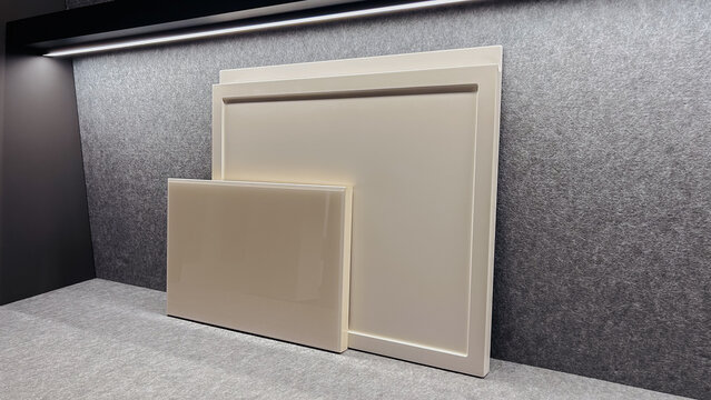 Modern beige panels for interior decor displayed on textured gray surface with LED light