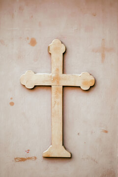 Close-up of a Christian cross mounted on a weathered church door in Athens, Greece, highlighting religious symbolism and historic architecture.