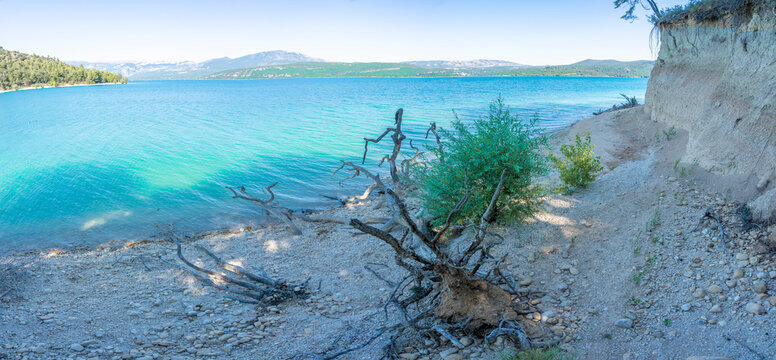Sainte-Croix-du-Verdon, France - 07 05 2026: Panoramic view of the Lake Sainte-Croix, beach, hills and forests in sunny blue sky
