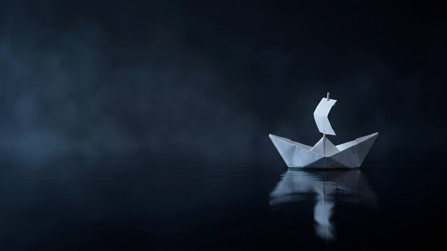 White paper origami boat floating on calm dark water with misty atmosphere and reflections