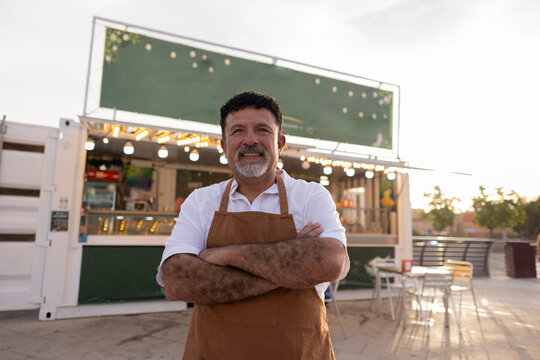 Smiling mature man owning food truck business