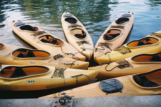 Yellow Kayaks Docked On Water