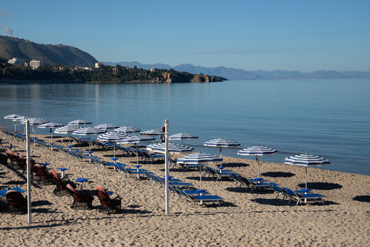 Cefalu Sicily coastal town with medieval cathedral and rocky cliff overlooking the sea and the beautiful beach in the mediterranean sea.