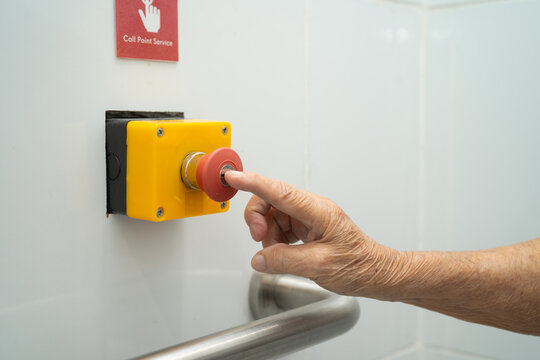 Asian woman patient press the emergency button in the bathroom.