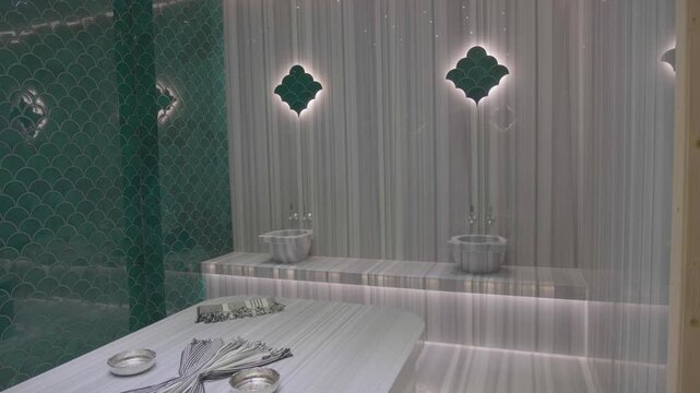 raditional Turkish bath interior with marble heated stone massage area and steam in luxury spa resort