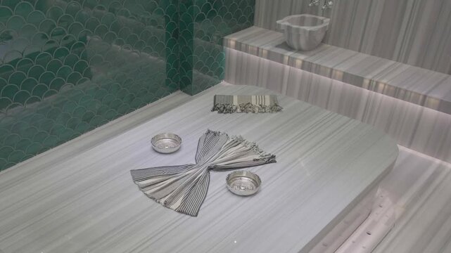 raditional Turkish bath interior with marble heated stone massage area and steam in luxury spa resort