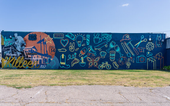 Killeen, TX - 10 July 2026: A large wall mural featuring numerous community icons and cultural symbols located in a downtown urban area.