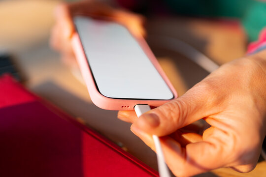 Plugging a Charging Cable into a Smartphone