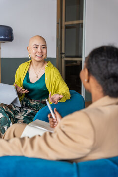 Women Talk and Share Ideas in a Modern Workspace During the Day