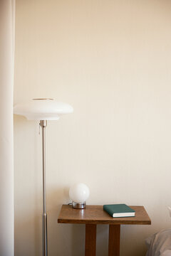 Bedside table with book and lamps