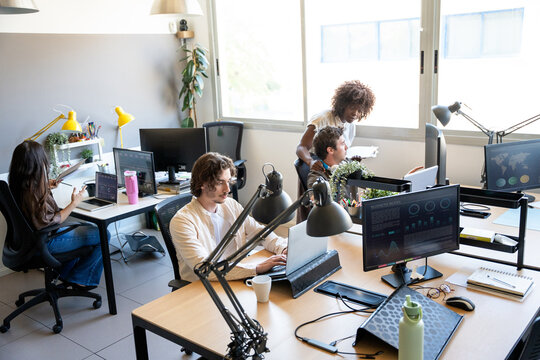 Coworkers collaborating and working in modern office