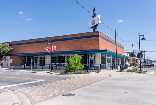 Killeen, TX - July 10 2026: An exterior view of a vacant commercial red brick building located on a city street corner in Texas
