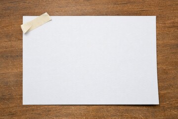 Fototapeta premium A piece of paper with a piece of tape stuck to it, ready for use