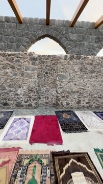Prayer rugs before the historic stone mihrab of Masjid Bani Anif in Madinah.