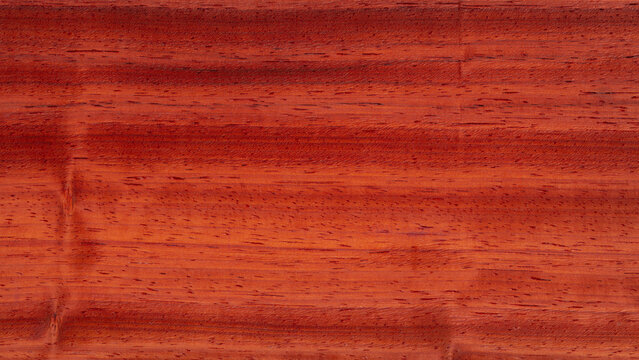 Padauk wood texture showing natural grain pattern