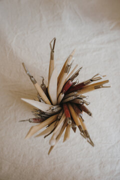 Close up of ceramic modeling tools on a textured linen.