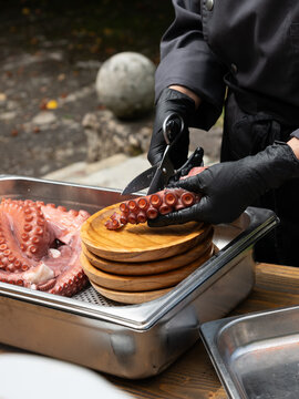 Chef Preparing Cooked Octopus for Serving