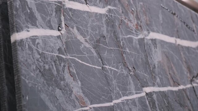 Heavy machinery cutting large marble block in natural stone factory production line