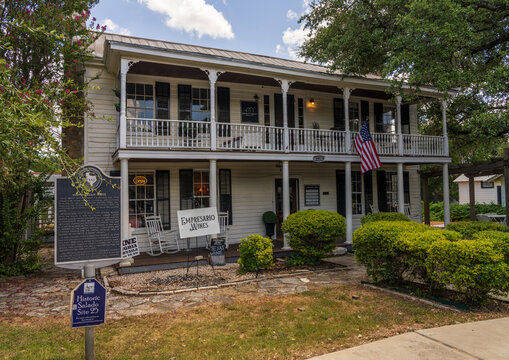 Salado, TX - 10 July 2026: The historic Norton Orgain House displays a state landmark sign and a rustic white porch with wooden chairs.