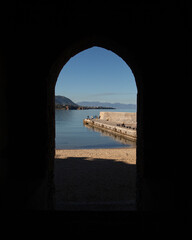 Fototapeta premium Cefalu, Italy; 1st January 2026: Porta Pescara, one of the city's ancient medieval gates, offering a picturesque view of the sea.