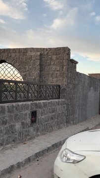 Exterior stone walls and courtyard entrance of the historic Masjid Bani Anif in Madinah.