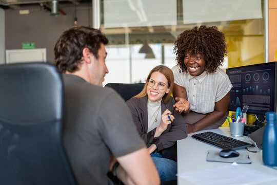 Diverse colleagues collaborating enjoying team discussion in office
