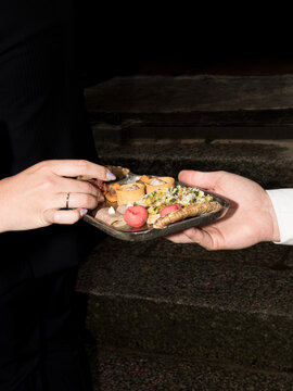 Guest Choosing Hors d&rsquo;Oeuvre from Catering Tray