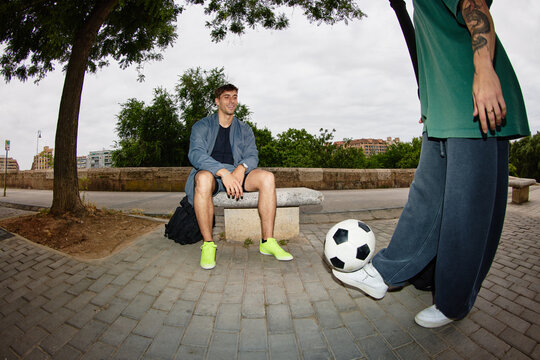 Friends spend time together playing soccer in the park