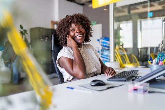 African american woman laughing in modern office