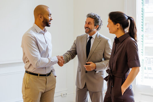 Business professionals shaking hands completing a successful deal