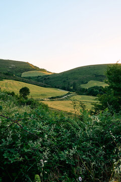 Cinematic sunset over a peaceful countryside valley and village