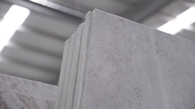 Heavy machinery cutting large marble block in natural stone factory production line