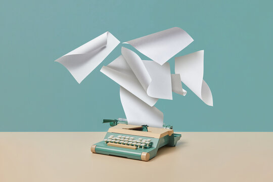 Vintage typewriter with flying blank paper sheets