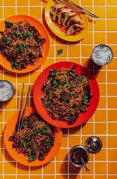 Beef stir fry noodles with side of dumplings