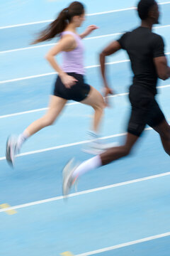 Motion blur photo of couple running