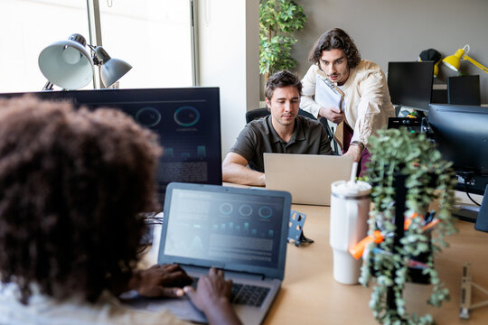 Colleagues collaborating on business data in modern office