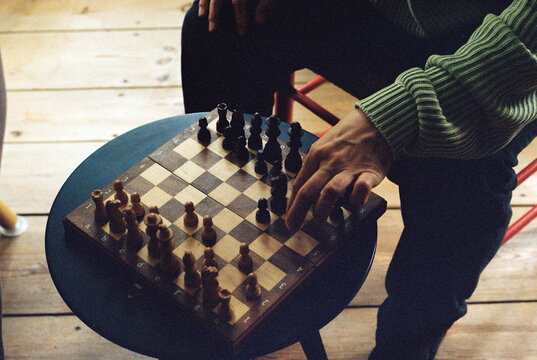 Person Making Move On Chessboard