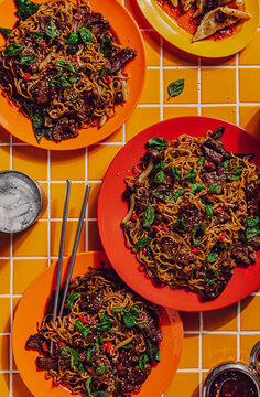 Beef stir fry noodles with side of dumplings