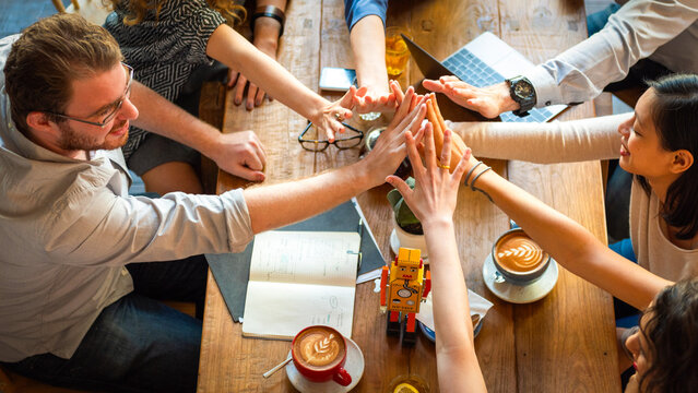 Teamwork celebration at coffee meeting