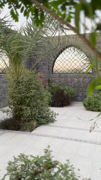 Serene stone arches and gardens at historic Masjid Bani Anif, Madinah.